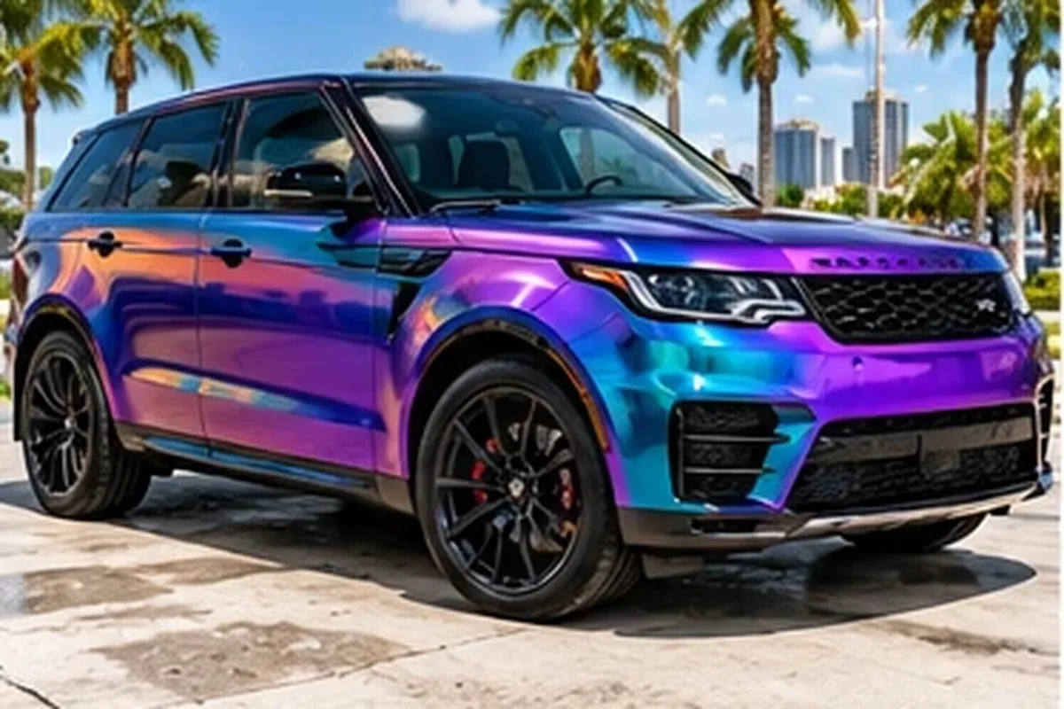 Color-shift purple and teal wrapped Range Rover with Las Vegas skyline